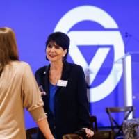 President Mantella speaks with two alumni